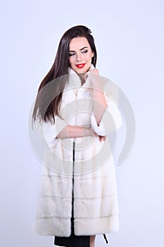 Confident young woman in mink coat