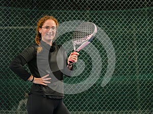 Confident Young Woman Padel Player on an outdoor Court