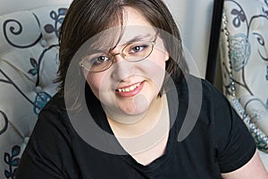 Confident young woman with short hair in her 20`s sitting in chair