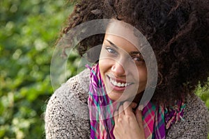 Confident young woman smiling outdoors