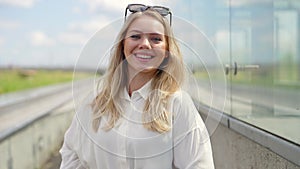 Confident Young Woman Smiling Outdoors in Summer