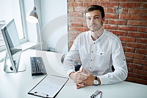 Confider handsome computer programme looking at the camera