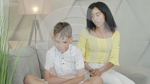 Conflict of African American mother and son at home. Portrait of dissatisfied woman scolding little boy. Child