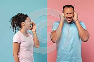 Conflict, family relationship problems. Angry black lady screaming at husband, mad man covering ears with hands