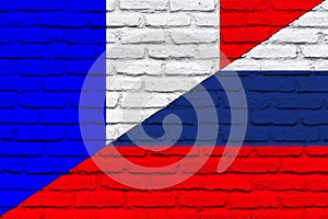 Conflict between France and Russia war concept. Russian flag and France flag background. Flag with brick wall texture.