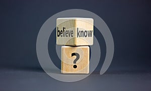 Conflict of knowing or believing. Wooden cubes with words `believe` and `know`. Beautiful grey background. Copy space. Concept photo