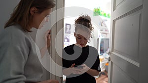 Conflict between mother and teenage daughter. The girl is fascinated by the phone. The mother tries to take the gadget