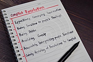 Conflict Resolution write on a book with keywords isolated wooden table