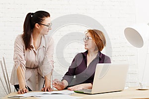 Conflict. Women discuss project in office