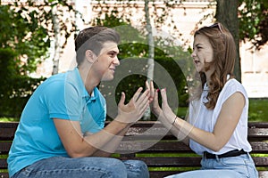 Conflicted couple not talking to each other seated on a wooden bench in park