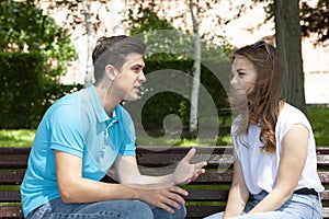 Conflicted couple not talking to each other seated on a wooden bench in park photo