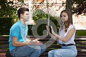 Conflicted couple not talking to each other seated on a wooden bench in park photo