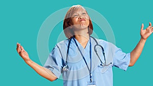 Conflicted nurse doing perplexed gesture photo