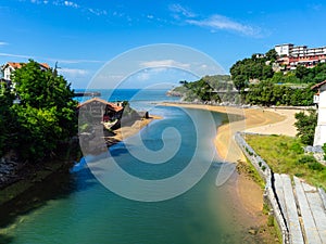confluence of the River Rio Lea into the Atlantic Ocean In Lekeitio. The mouth of the river Lea Basque Country, Spain photo