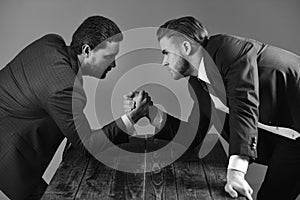 Confrontation of business leaders. Men in suit or businessmen with tense faces compete