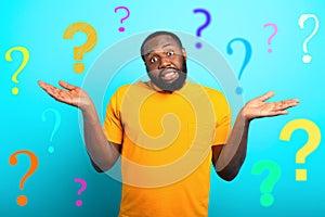 Confuse and pensive expression of a boy with many questions . cyan colored background