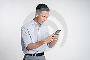 confuse young businessman while looking at his smartphone