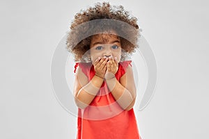 Confused african american girl covering mouth