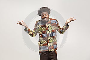 Confused afro man puzzled and say don`t know, maybe