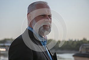 Confused aged man looking away. Greyhaired man portrait