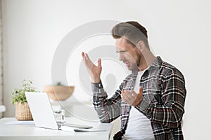 Confused angry man frustrated by online problem, hate stuck lapt