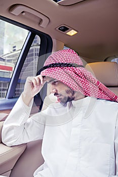 Confused Arabian man sitting in the car