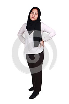 Confused Asian muslim woman wearing hijab thinking hard, hands on hips and looking up, full body portrait