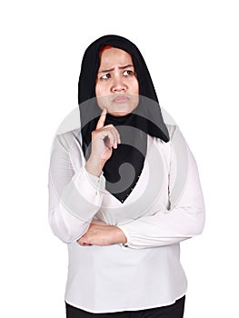 Confused Asian muslim woman wearing hijab thinking hard, touching chin and looking up