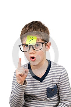 Confused boy thinking with question mark on sticky note on forehead