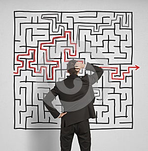 Confused business man seeks a solution to the labyrinth