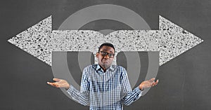 Confused business man standing against grey background with white arrows