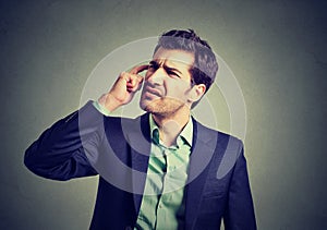 Confused business man thinking scratching his head photo