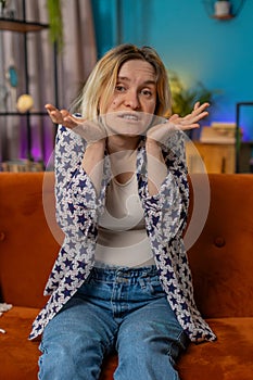 Confused Caucasian woman feeling embarrassed about ambiguous question having doubts no idea clueless photo