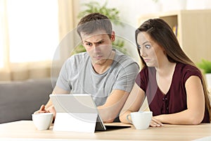 Confused couple receiving on line news