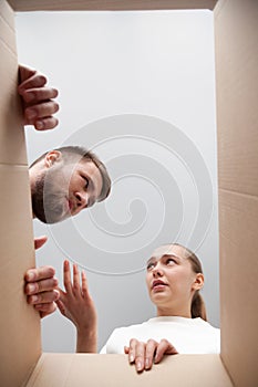 Confused customers dissatisfied with delivered parcel, view from