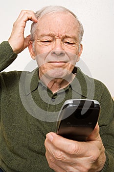 Confused elderly man with remote control