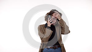 Confused European woman holding cellphone having problem with the calling person, frustrated angry girl received bad