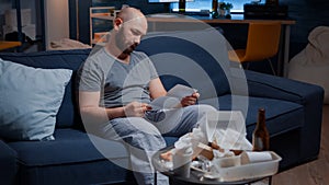 Confused frustrated stressed young man reading letter