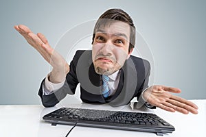 Confused frustrated and unsure man is working with computer