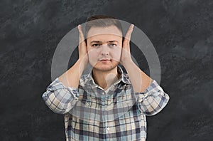 Confused man puts his hands on head