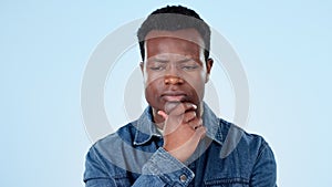 Confused man, studio or thinking of plan with doubt, brainstorming why or remember questions on blue background. African