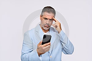 Confused middle aged business man looking at smartphone isolated on white.