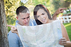 Confused Mixed Race Couple Looking Over Map Outside