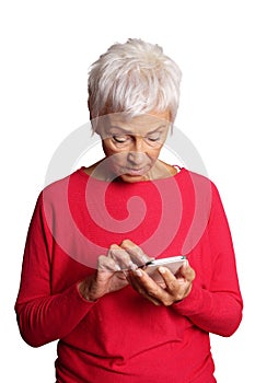 Confused senior woman using smartphone