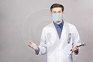 Confused serious male doctor looking at you with stethoscope around his neck, serious face
