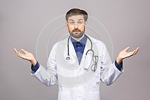 Confused serious male doctor looking at you with stethoscope around his neck, serious face