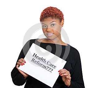 Confused, skeptical woman holding sign, health care reform