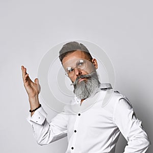 Confused stylish bearded hipster man in eyewear raising hand photo