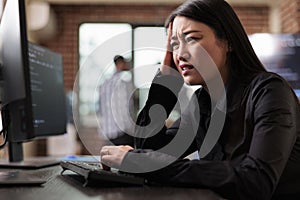 Confused tech engineer sitting at computer trying to solve network processing errors.