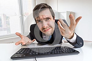 Confused and unsure man is working with computer